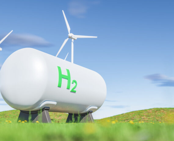 3D illustration of modern cistern with H2 inscription located near windmills against blue sky in daylight in countryside