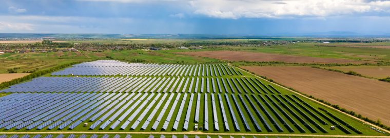 Aerial view of big sustainable electric power plant with many rows of solar photovoltaic panels for producing clean ecological electrical energy. Renewable electricity with zero emission concept.